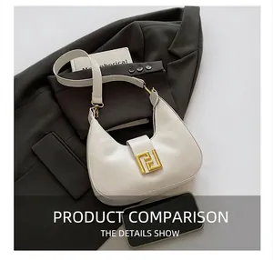 Detail showing the white crescent bag with its signature gold metal buckle and smooth leather
