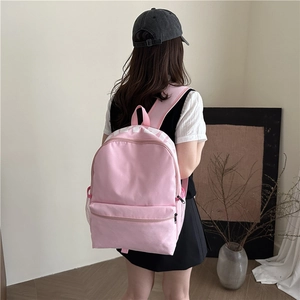 Minimalist pink nylon student backpack with white letter print and side mesh pockets