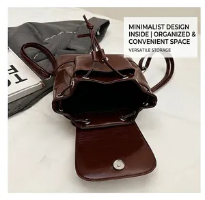 Internal view of the dark brown leather backpack with drawstring closure and large capacity