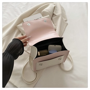 Detailed interior of pink and white PU leather crossbody bag showing daily essentials space