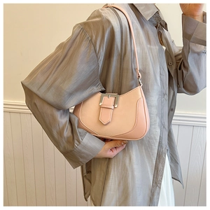 Detail view of pink leather hobo bag with stylish metal buckle on shoulder strap