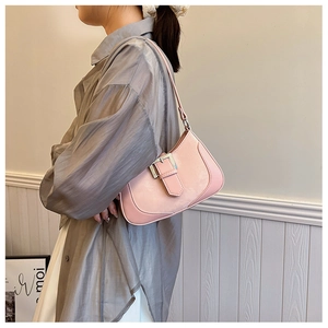 Pink crescent underarm bag with silver metal buckle shown worn on model shoulder