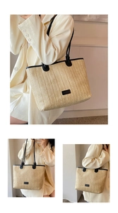 Detail of a large straw tote bag with black trim and leather straps for summer beach travel