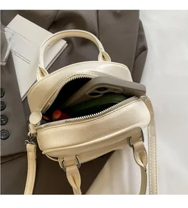 Internal view of chic cream shell bag showing spacious capacity for phone and cosmetics