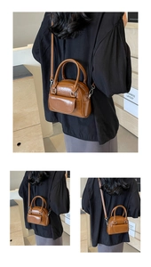 Detail view of a vintage caramel shell bag with glossy finish and detachable strap