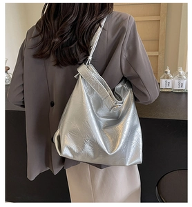 Detail of silver metallic hobo bag featuring fashionable pleated texture and large capacity