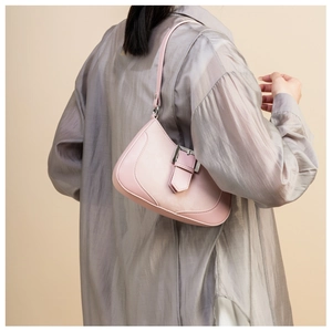 Detail of light pink crescent underarm bag with large silver metal buckle on model