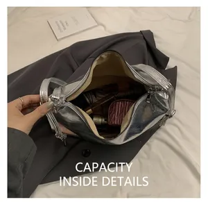 Detail view of the spacious inner compartment of the silver metallic PU shoulder bag