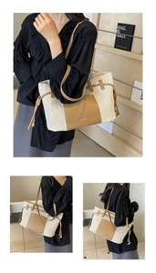 Detail view of woven straw tote bag with brown leather pocket and adjustable shoulder strap