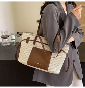 Detail of woven straw tote bag with leather straps and Fashion & Bags embossed logo