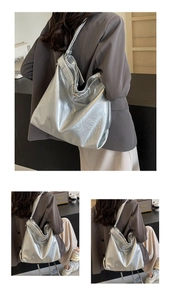 Detailed view of large silver tote bag with liquid metal texture and soft pleated design