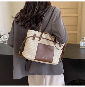 Detail of woven tote bag with brown leather front pocket and Fashion & Bags text