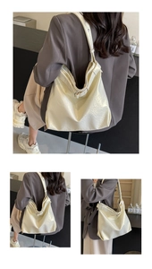 Detail view of cream white bucket bag with pleated texture and adjustable strap