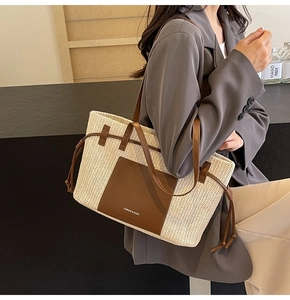 Side view of woven tote bag with brown leather straps and drawstring detail on model