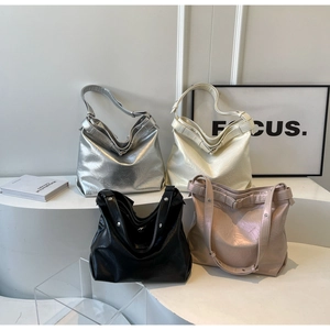 Detailed view of large capacity tote bags in silver, white, black and pink faux leather