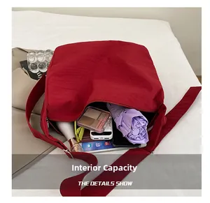 Detailed interior view of a spacious burgundy nylon bag showing large storage capacity
