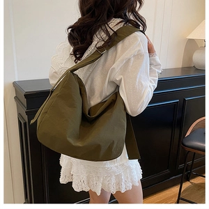 Olive green large capacity tote bag shown on model for size and casual style reference