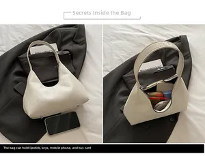 Detail view of beige snakeskin hobo bag showing spacious main compartment for daily items