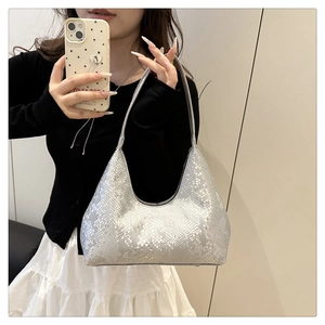 Mirror selfie showing a silver snake pattern hobo bag with metallic finish and PU leather