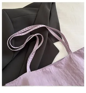 Detail view showing soft lavender fabric texture and comfortable double shoulder straps of the bag