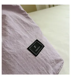 Macro detail of lavender textile fabric with textured weave and stitched brand label