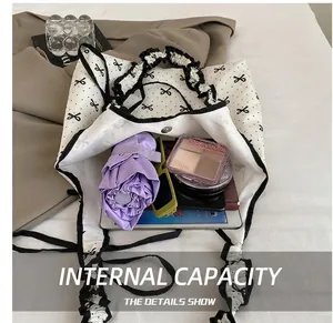Interior view showing large capacity of the polka dot tote bag with ruffles and accessories
