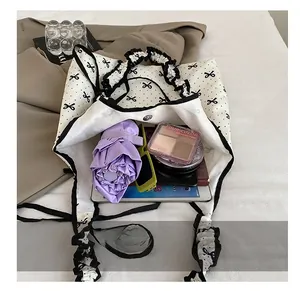 Interior view showing large capacity of the polka dot tote bag with ruffles and accessories