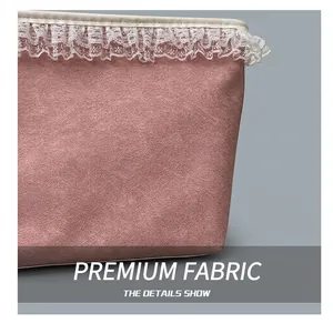 Detailed macro view of pink matte fabric and delicate white lace trim on the tote bag