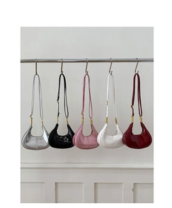 Five assorted glossy leather crescent shoulder bags hanging in silver, pink and black