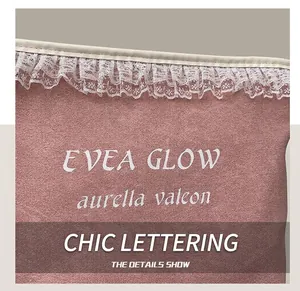Close-up of pink suede tote bag featuring delicate white lace trim and EVEA GLOW text