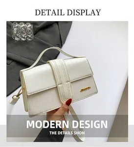 Macro view of creamy white crossbody bag showing croc texture and golden JINGPIN logo