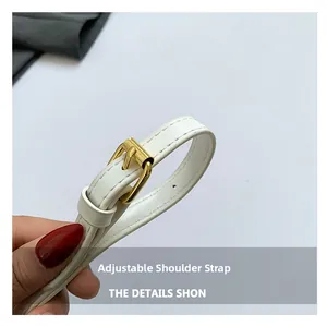 Detail of adjustable white leather shoulder strap with gold buckle and neat stitching
