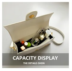 Detail view of the open white handbag showing space for smartphone and makeup