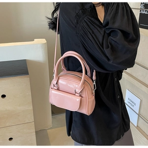 Nahaufnahme der rosa Lackleder-Muscheltasche mit Silberreißverschluss und kleiner Vordertasche