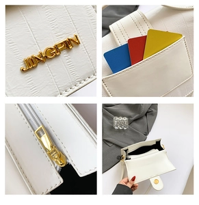 Detail view of white crocodile pattern bag featuring card slots and gold hardware zipper
