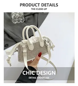 Detail of white mini rhinestone handbag with satin drawstring lining and top handles