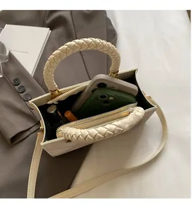 Detail of the spacious interior compartments of the cream crossbody bag for essentials