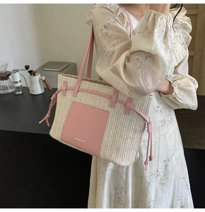 Detail of woven straw tote bag with pink leather patch and fashion text for beach vacation