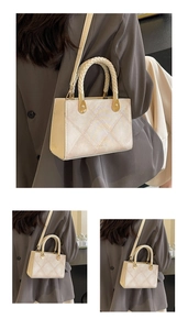 Detail of beige square handbag with woven handle, quilted texture and gold hardware
