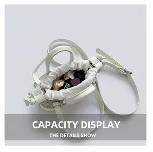 Internal capacity of white rhinestone bucket bag showing space for lipsticks and cosmetics