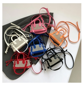 Close-up of six colorful mini crossbody bags with sparkling rhinestone crystal embellishments
