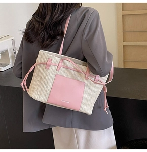 Detail view of the pink and cream woven tote bag showing the side drawstring and texture