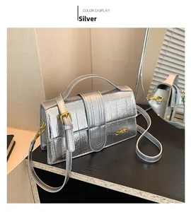 Silver metallic quilted shoulder bag shown with elegant mirror reflection and light shadow