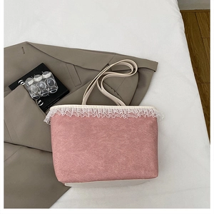 Détail du sac cabas rose en toile avec bordure en dentelle blanche et poignées