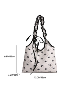 Polka dot canvas tote bag with black ruffle handles and bow detailing for women