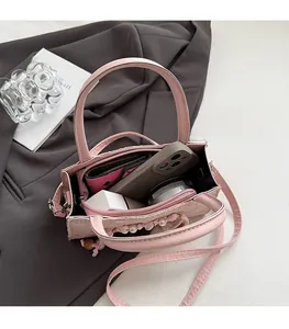 Pink leather handbag interior showing high capacity for phone and makeup storage