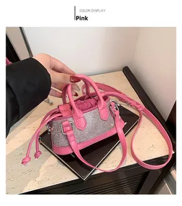Detailed view of pink rhinestone mini bag with adjustable strap and drawstring pouch