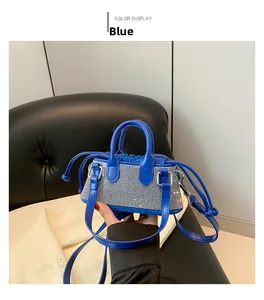 Detail of a blue leather handbag with crystal rhinestones and drawstring closure