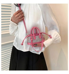 Detail of pink rhinestone mini bag with drawstring and detachable crossbody strap
