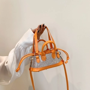 Mini orange rhinestone tote bag with a silver crystal mesh finish and a detachable strap
